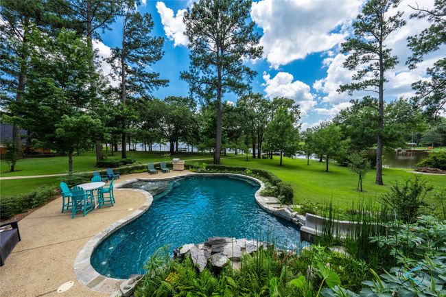 View of pool featuring a lawn | Image 35