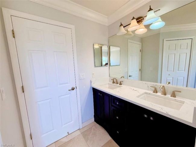 Full bath featuring double vanity, crown molding, tile patterned flooring, and a sink | Image 18
