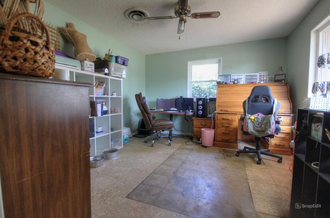 Office area with ceiling fan and a textured ceiling | Image 9
