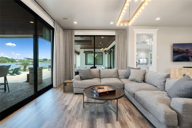 Living room featuring wood finished floors, a chandelier, and recessed lighting | Image 13