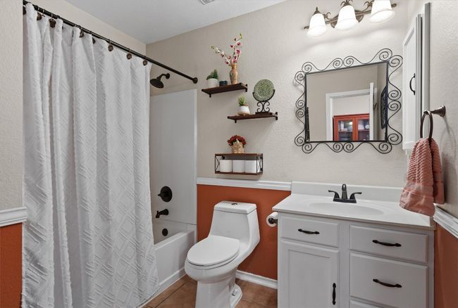 Bathroom with vanity, tile flooring, and shower / bath combo. | Image 17
