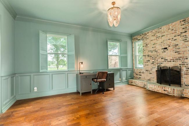The home features a spacious office or formal dining with a fireplace, conveniently located just off the foyer, offering both elegance and functionality. | Image 13
