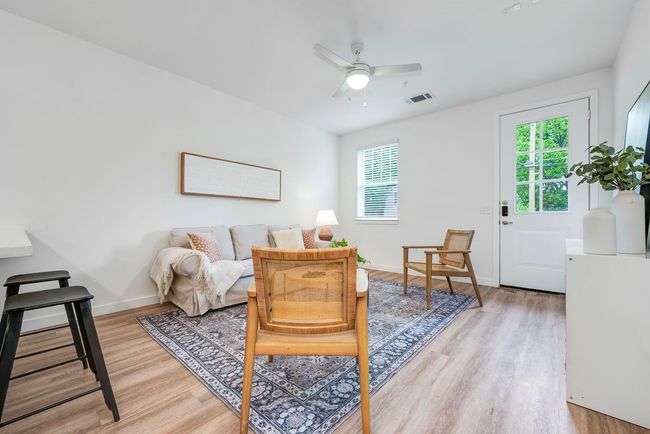 Sitting room with light wood-style floors, healthy amount of natural light, a ceiling fan, and baseboards | Image 10