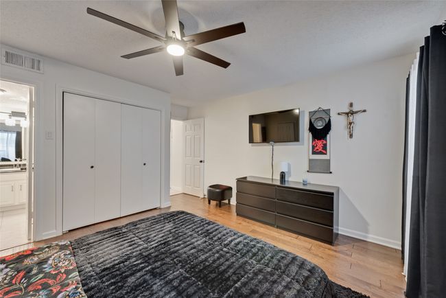 Bedroom with light wood finished floors, a closet, a ceiling fan, and ensuite bath | Image 14