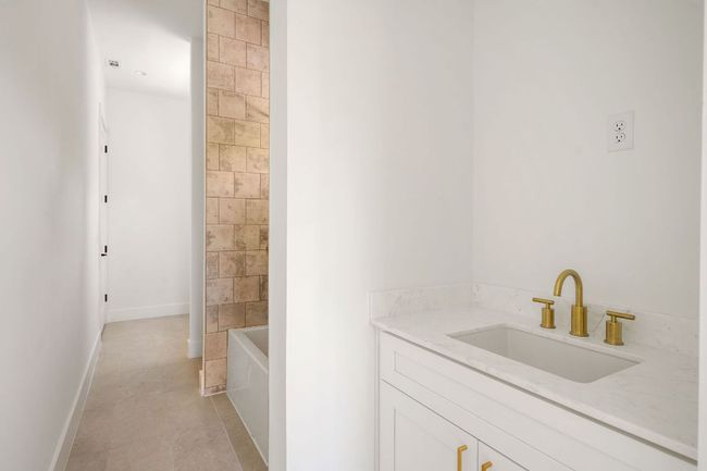 Bathroom with tile patterned floors, vanity, and baseboards | Image 16