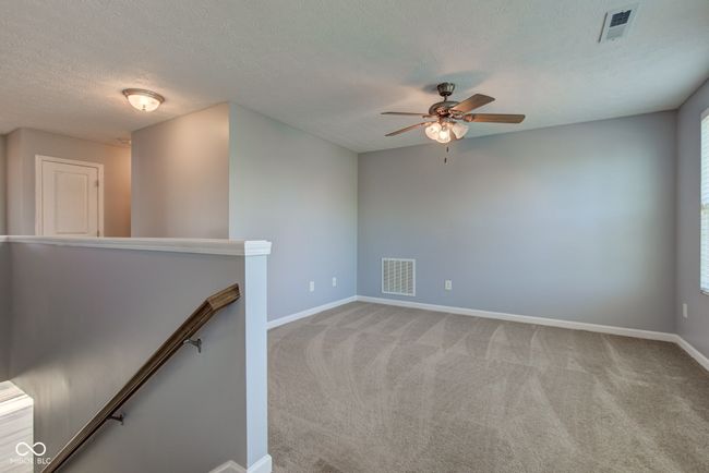 spare room featuring a ceiling fan, carpet, and a textured ceiling | Image 29