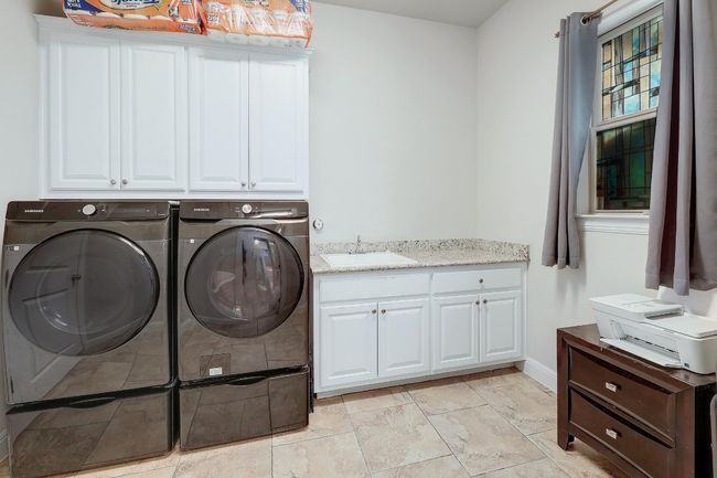 Laundry room with independent washer and dryer and cabinet space | Image 32