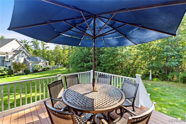 Wooden deck featuring outdoor dining area and a yard | Image 45