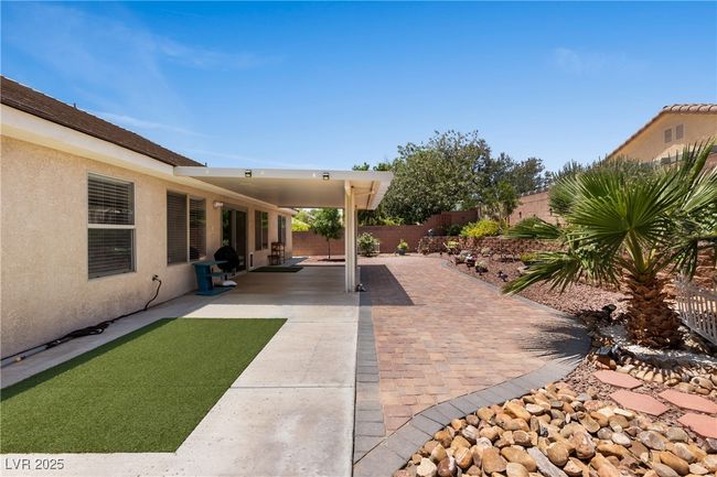Fenced backyard with a patio area | Image 35