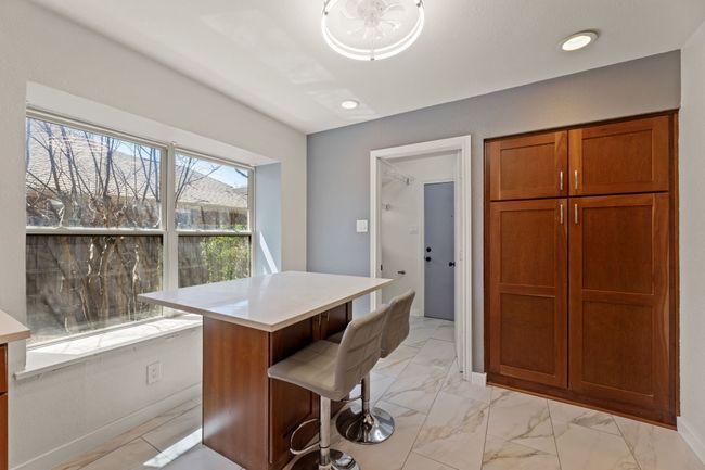Dining room with marble finish floor and recessed lighting | Image 11