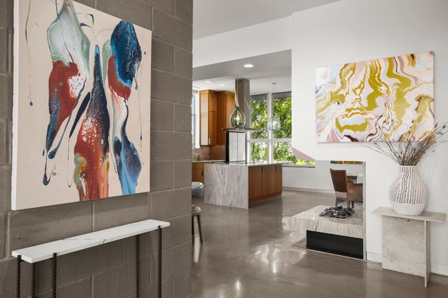 Water vapor "fireplace" brings warmth and the beauty of waterflow to the center of the home in a curved custom housing, with matching Armani hearth. | Image 13