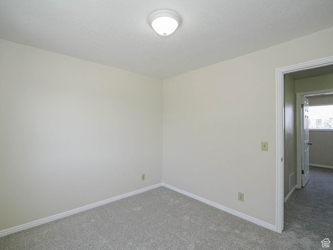 Carpeted spare room with baseboards | Image 43