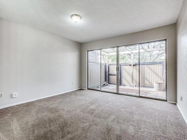 Carpeted spare room with a textured ceiling and baseboards | Image 5