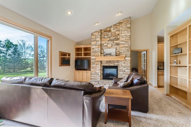 Fantastic Family Room on the main level with built-ins and the 2-sided gas fireplace. | Image 10