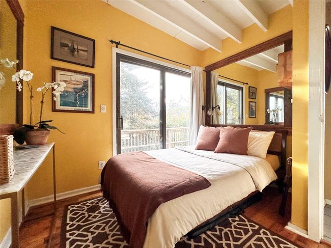 Bedroom featuring access to outside and wood finished floors | Image 12