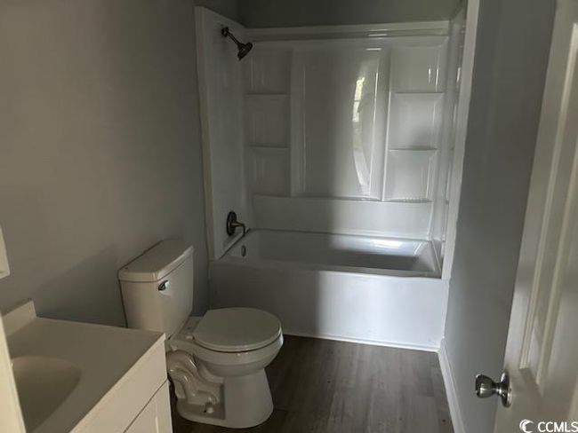 Bathroom featuring vanity, shower / washtub combination, wood finished floors, and toilet | Image 23
