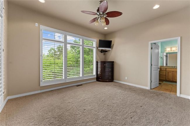Unfurnished bedroom featuring connected bathroom, visible vents, baseboards, carpet floors, and recessed lighting | Image 42