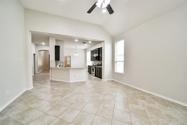 Turn around and notice how large this space is and how it opens up seamlessly into the kitchen. | Image 6