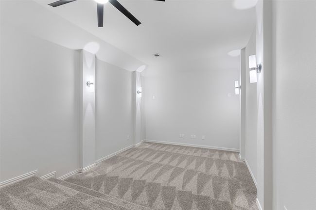 Spare room with baseboards, light carpet, and ceiling fan | Image 26
