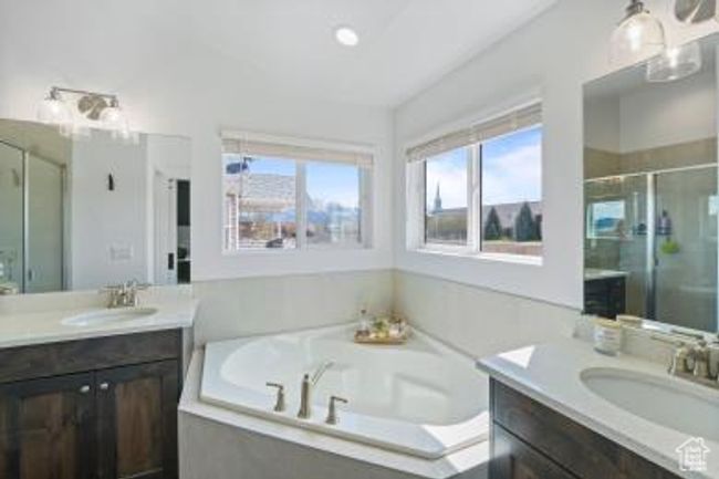 Bathroom with a bath, a sink, two vanities, and a stall shower | Image 20