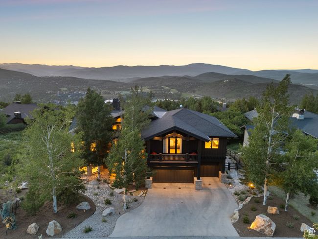 View of front of house featuring a garage, a mountain view, driveway, and stairs | Image 7