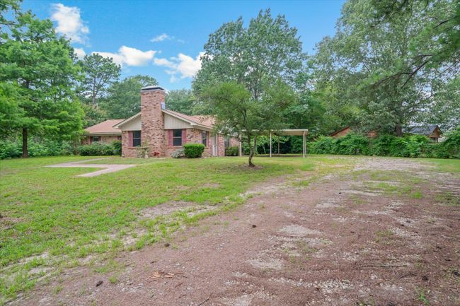 Rear view of property with a chimney, brick siding, and a yard | Image 34