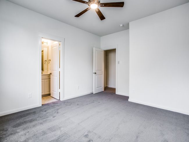 Unfurnished bedroom featuring carpet floors, connected bathroom, and a ceiling fan | Image 19