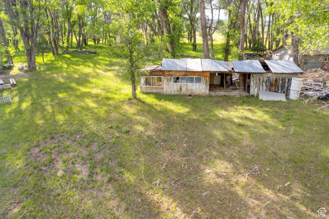 View of front of house featuring a front lawn and a metal roof | Image 46
