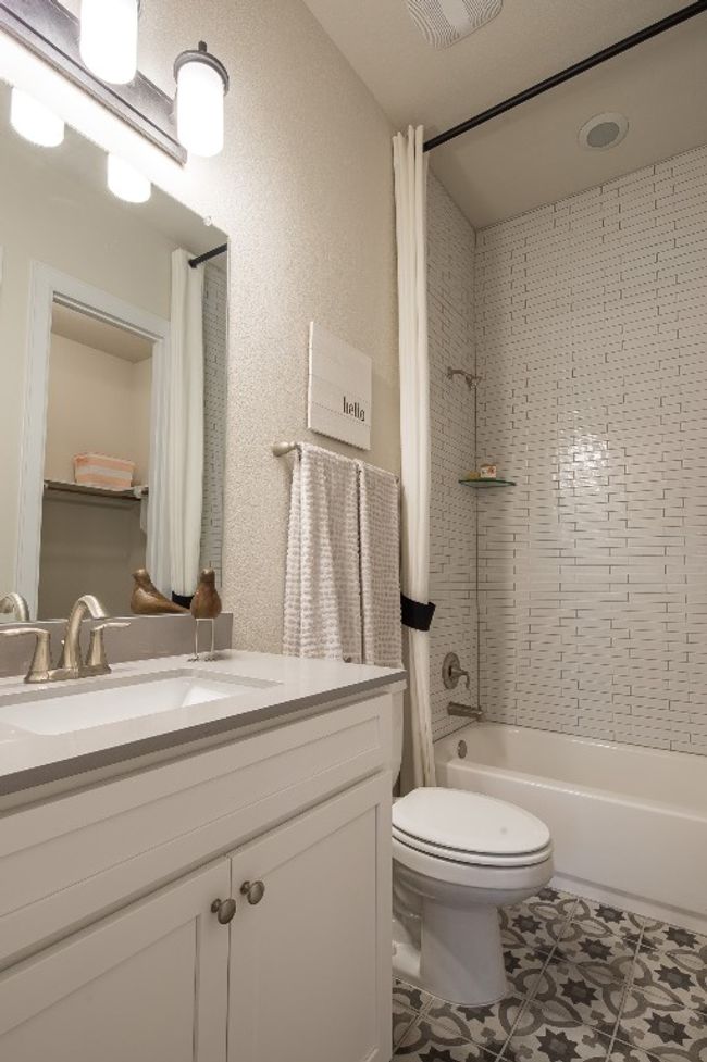 Full bathroom with vanity, toilet, shower / tub combo with curtain, and tile patterned floors | Image 7