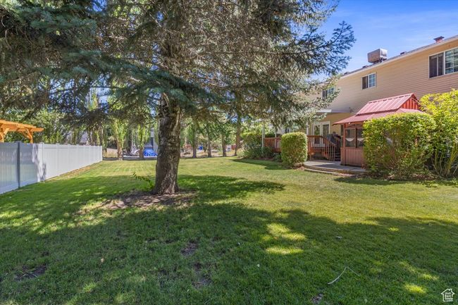 View of yard featuring a deck | Image 42