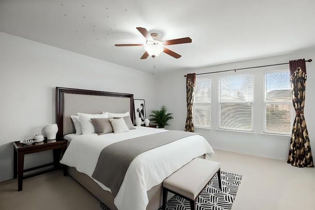 Carpeted bedroom with a ceiling fan | Image 13
