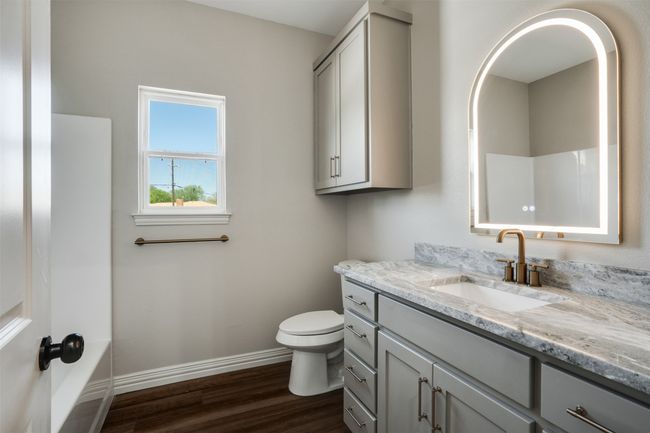 Full bath featuring baseboards, wood finished floors, vanity, and toilet | Image 22