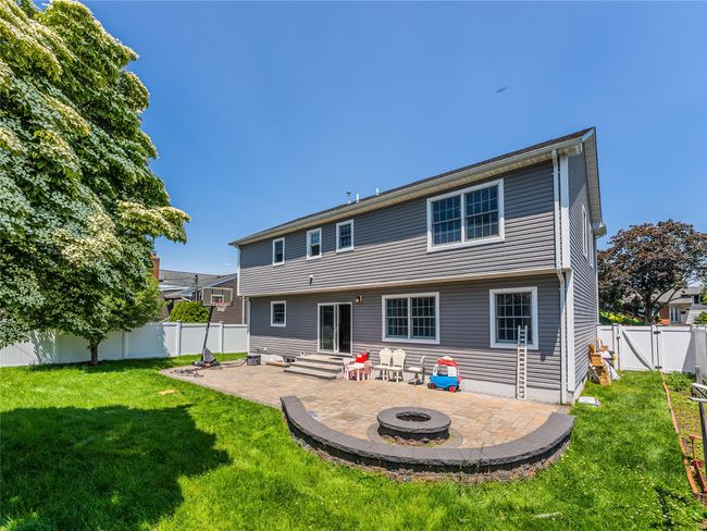 Back of property with a patio area, an outdoor fire pit, and a gate | Image 30
