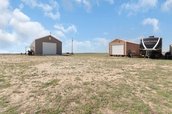 View of yard with a garage, an outbuilding, and driveway | Image 27