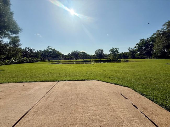 Additional concrete patio off the breezeway between house and garage | Image 44