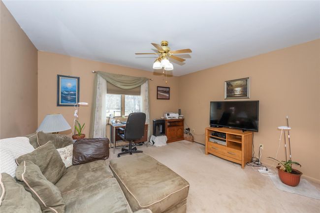 Living area featuring light carpet and a ceiling fan | Image 19
