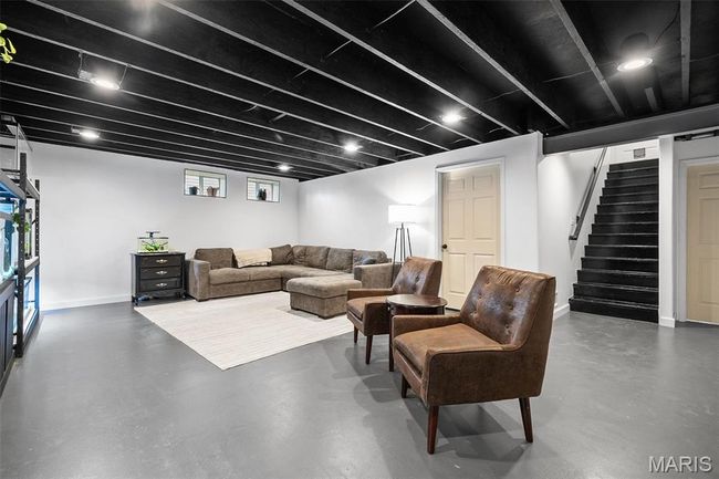 Living area with concrete floors and stairs | Image 26