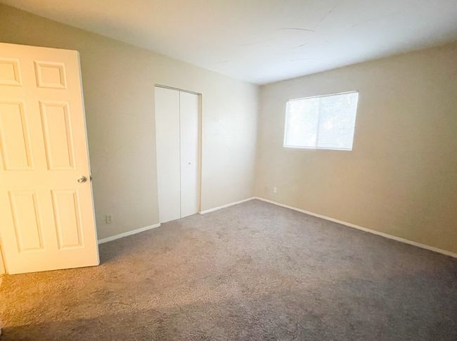 Unfurnished bedroom featuring carpet floors, baseboards, and a closet | Image 5