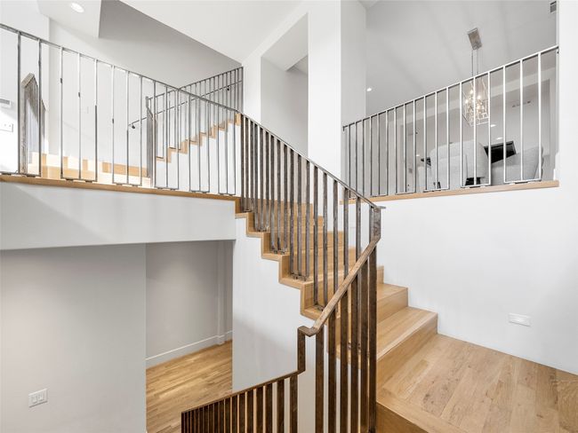 Stairway featuring wood finished floors | Image 9