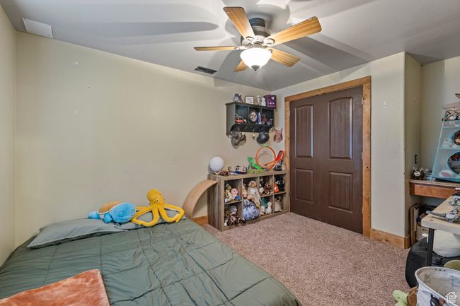 Bedroom with carpet, ceiling fan, and baseboards | Image 26