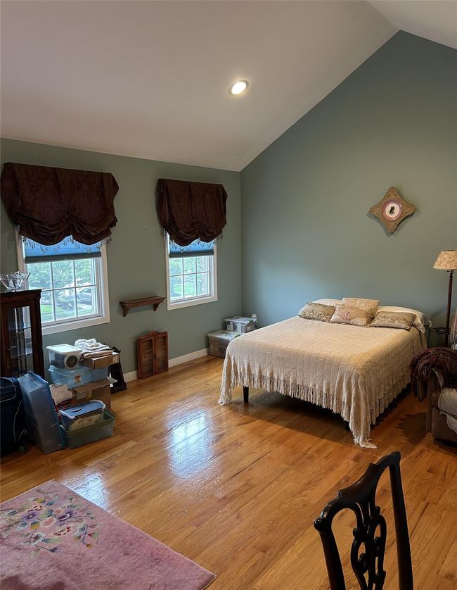 Bedroom featuring lofted ceiling, wood finished floors, and recessed lighting | Image 26