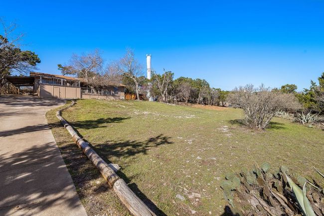 View of yard featuring a carport and concrete driveway | Image 31