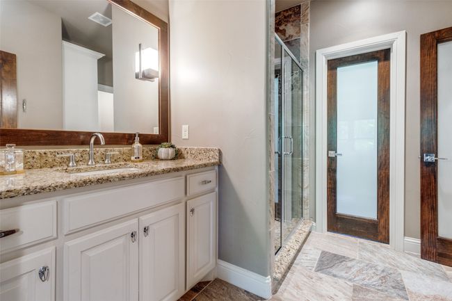 Bathroom featuring tile floors, an enclosed shower, and vanity | Image 14