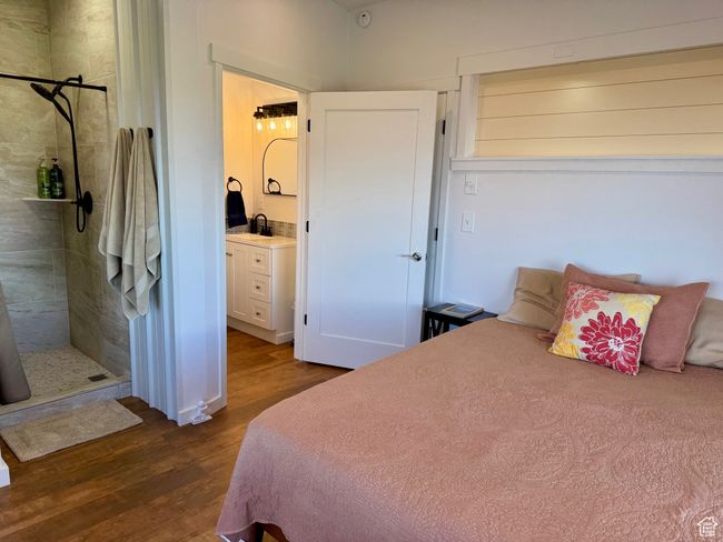 Primary Bedroom with wood-type finished floors, separate sink/toilet and walk-in shower, and new bedroom furniture. | Image 10