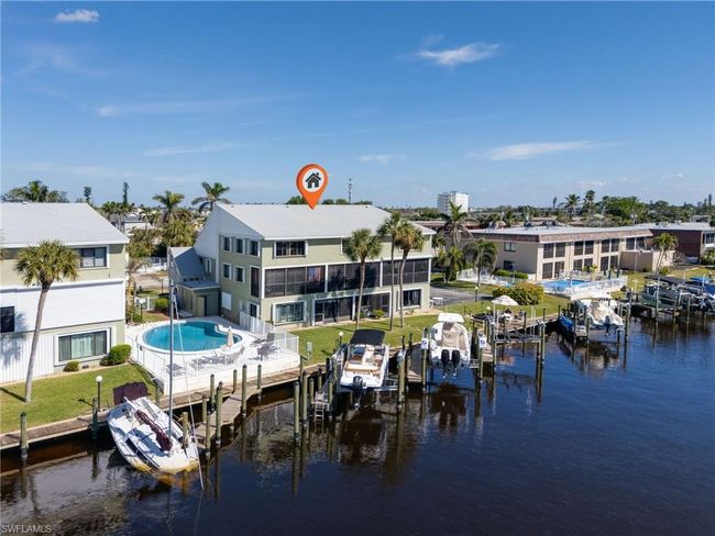View of dock featuring a swimming pool and a water view | Image 24