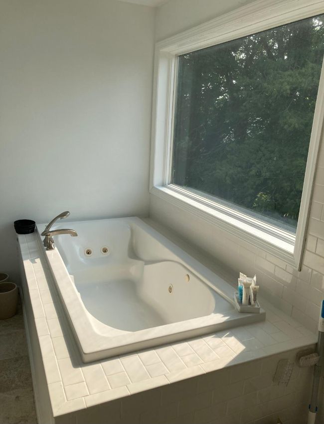 Bathroom with a tile shower and tile patterned flooring | Image 45