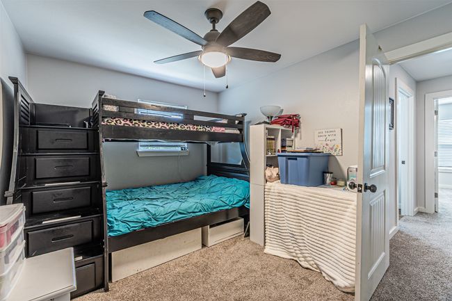 Carpeted bedroom featuring a ceiling fan | Image 24