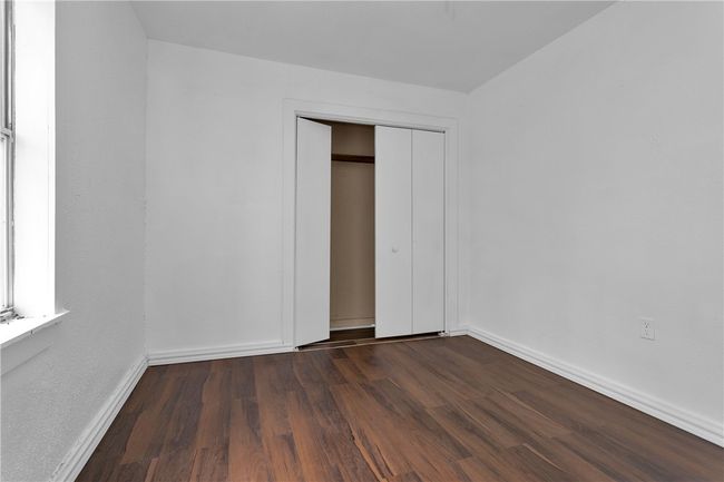 Unfurnished bedroom featuring a closet and wood finished floors | Image 26