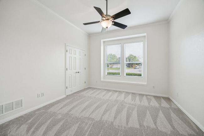 bedroom with crown molding, baseboards, and a ceiling fan | Image 22