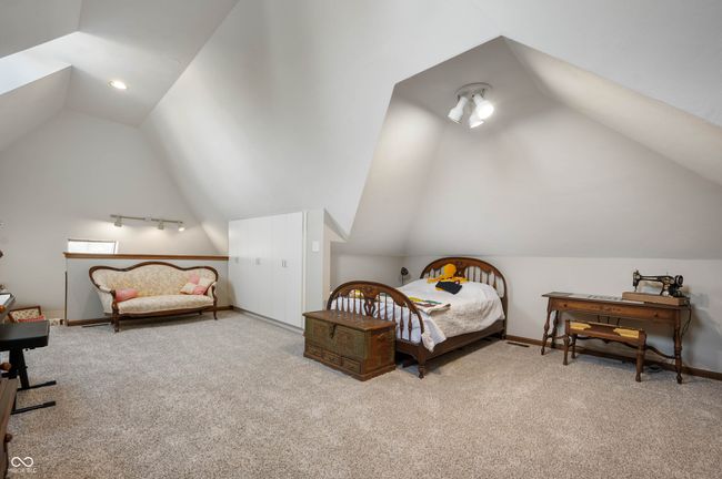 bedroom featuring vaulted ceiling, carpet flooring, and baseboards | Image 29